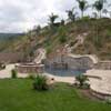 Slide, Gray plaster, Raised bond beam with natural flagstone 